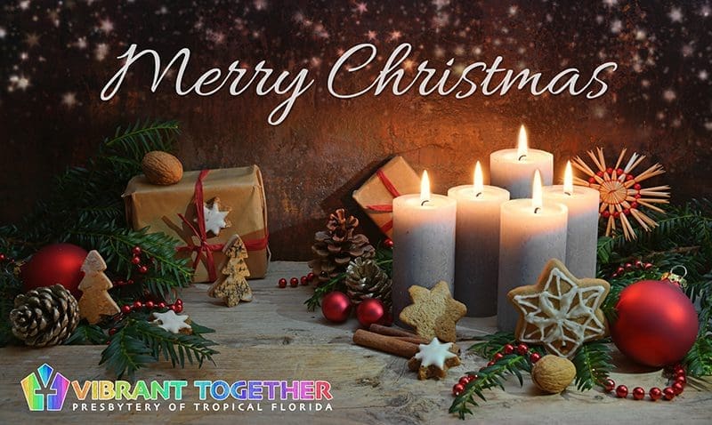 Fourth Advent, four candles are lighted, Christmas decoration and gifts on rustic wooden planks against a dark brown background with copy space, selected focus
